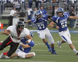  .          ROBERT  K. YOSAY | THE VINDICATOR..Canfield #9 Kimu Kim is pulled down by #4 Poland  Dylan Garver as #57  Colin Rody and#52  Mike Audi look on.. he was stopped for a loss in first quarter action..Canfield at Poland