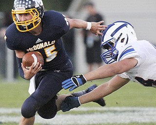 William d Lewis the Vindicator McDonald QB(25) eludes Western Reserve's (44) during 1rst half action 9-27-13 at McDonald.