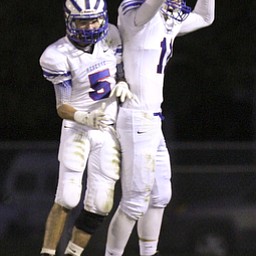 William d Lewis the Vindicator Western Reserve's (11) reacts after scoring during 1rst half action 9-27-13 at McDonald.With him is (5).