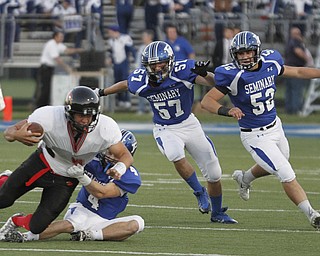 . ROBERT K. YOSAY | THE VINDICATOR..Canfield #9 Kimu Kim is pulled down by #4 Poland Dylan Garver as #57 Colin Rody and#52 Mike Audi look on.. he was stopped for a loss in first quarter action..Canfield at Poland