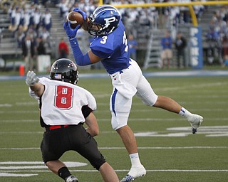  .          ROBERT  K. YOSAY | THE VINDICATOR..Poland #3 Tyler Evan pulls in a pass in front of Canfields #8 Matt Milligan for a first down during first quarter action at Poland..Canfield at Poland