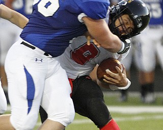  .          ROBERT  K. YOSAY | THE VINDICATOR..Polands #56  Zach Bader  crushes Canfieds #9 Kim Kim behind the line for a loss during first half action..Canfield at Poland