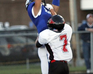  .          ROBERT  K. YOSAY | THE VINDICATOR..Polands #8  George Chammas  Jumps up for the a touchdown as #7 Nick Luchansky from Canfield trys  to defend..Canfield at Poland