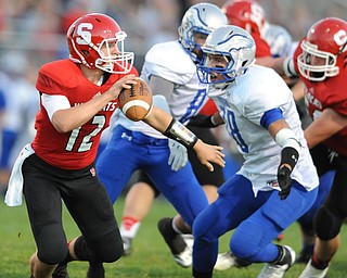 David W. Dermer | The Vindicator.Struthers quarterback #12 Gary Muntean attempts to escape from Hubbard defensive linemen #78 Jake Frost during the 1st quarter of a game on September 27, 2013.