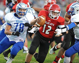 David W. Dermer | The Vindicator.Struthers quarterback #12 Gary Muntean attempts to escape from Hubbard defensive linemen #78 Jake Frost and linebacker #6 Cole Benectic during the 1st quarter of a game on September 27, 2013.