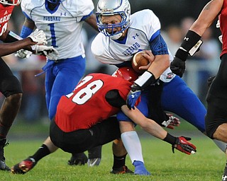 David W. Dermer | The Vindicator.Hubbard quarterback #7 Brennan Wassil lowers his shoulder and runs through Struthers defensive back #28 Anthony Farkas during the 1st quarter of a game on September 27, 2013.