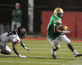 Ursuline running back #5 Damon Green runs the ball up the sideline after getting the corner around Cathedral Prep defensive back #28 William Monono on a option play.