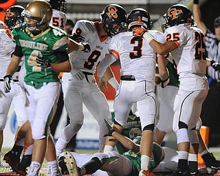 Cathedral Prep players #3 Billy Fessler #25 DeAngelo Malone, and #9 Charles Fessler celebrate after a Fessler touchdown run on top of Ursuline #8 Dion Edwards and #20 David Collins, while #4 Anthony Protopapa walks to the sideline.