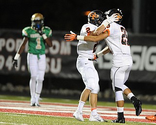 Cathedral Prep #2 Jake DeHert and #25 DeAngelo Malone celebrate after a touchdown while Ursuline #1 Ben Phillips walks to the sideline.