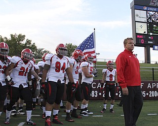Youngstown State head coach Eric Wolford (right) leads the Penguins onto the field before the start of Saturdays matchup against Southern Illinois University in Carbondale Illinois. Dustin Livesay | The Vindicator 9/28/13 Carbondale Illinois.