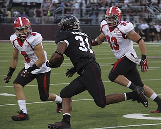 Southern Illinois running back Malcolm Agnew (31) attempts to rush the ball but is tackles for a loss by Donald D'Alesio (8) and Kyle Sirl (33) during the first quarter of Saturday's matchup at Southern Illinois University in Carbondale Illinois. Dustin Livesay | The Vindicator 9/28/13 Carbondale Illinois.