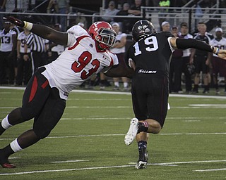 Youngstown State defensive tackle Emmanual Kromah (93) gets a grip on Southern Illinois University's quarterback Kory Faulkner (19) during the first quarter of Saturday's matchup at Southern Illinoi University in Carbondale Illinois. Dustin Livesay | The Vindicator 9/28/13 Carbondale Illinois.