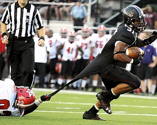 Southern Illinois' Malcolm Agnew runs in for a touchdown as Youngstown State's Emmanuel Kromah tries to pull him down by his jersey during the first half of the teams game at Saluki Stadium on Saturday, Sept. 28, 2013, in Carbondale, Ill. (Paul Newton / The Southern)