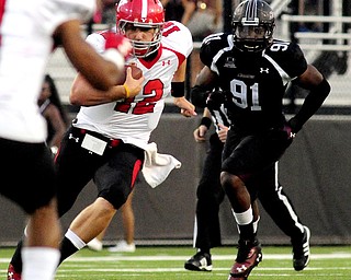 Youngstown State's Kurt Hess runs the ball in front of Southern Illinois' Kitray Solomon during the first half of the teams game at Saluki Stadium on Saturday, Sept. 28, 2013, in Carbondale, Ill. (Paul Newton / The Southern)