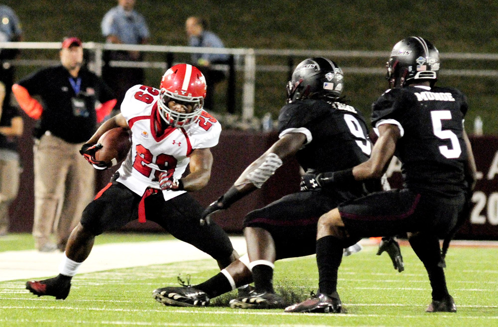Youngstown State's Martin Ruiz puts a move on Southern Illinois' Bryan Presume (9) and Southern Illinois' Terrell Wilson during the second half of the Salukis' 28-27 loss to the Penguins at Saluki Stadium on Saturday, Sept. 28, 2013, in Carbondale, Ill. (Paul Newton / The Southern)