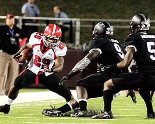 Youngstown State's Martin Ruiz puts a move on Southern Illinois' Bryan Presume (9) and Southern Illinois' Terrell Wilson during the second half of the Salukis' 28-27 loss to the Penguins at Saluki Stadium on Saturday, Sept. 28, 2013, in Carbondale, Ill. (Paul Newton / The Southern)