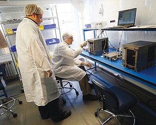 Project manager Matthew Napoli, far left, and director of research and development Michael Snyder test a 3-D printer, which eventually will be used in space, at Made in Space in Mountain View, Calif. One of the biggest
obstacles to space exploration is that you need to bring everything with you: tools, equipment, spare parts,
satellites. NASA is working with a Silicon Valley company to make specialized 3-D printers that would allow astronauts to produce the things they need on demand when they’re in space, allowing them to travel farther from the Earth.