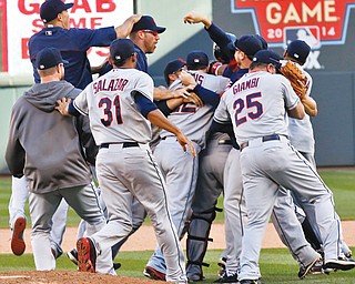 Indians’ players celebrate clinching a wild-card berth in the American League Central Division following their 5-1 victory over the Minnesota Twins on Sunday at Target Field in Minneapolis. The last time Cleveland made it into the postseason was 2007.