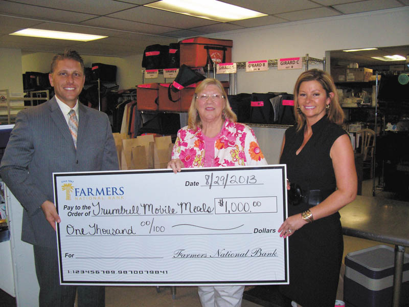 SPECIAL TO THE VINDICATOR
Trumbull Mobile Meals recently received a donation of $1,000 from Farmers National Bank for the Basket Extravaganza that will take place Nov. 9 at W.D. Packard Music Hall, 1703 Mahoning Ave. NW, Warren. From left are Philip Lammers, investment adviser representative for Farmers National Bank; Sandra L. Mathews, chief executive officer of Trumbull Mobile Meals; and Kerry Pizzulo, Farmers National Bank, Niles branch manager. The event will feature themed baskets and items to win, food and entertainment. It will benefit those in the community who face hunger and those who are limited in mobility.
