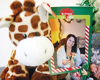 A photo of Brittany Mowry is attached to a stuff ed giraffe, her favorite animal. Brittany died Aug. 3 of cystic
fibrosis, and now her mother and other family members and friends are having a benefit dinner to help pay for funeral expenses.