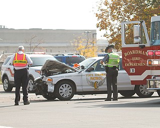 An Ohio State Highway Patrol trooper responding to a car accident Wednesday drove through a red light at the intersection of U.S. Route 224 and state Route 7, and collided with a Chevrolet Impala, which got pushed into a BMW.