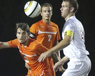 William d Lewis the Vindicator Howland's Benji rush(5) and Canfield's Brady Clark(16) battle for the ball. In background is Howland'sTyler Spain (7)