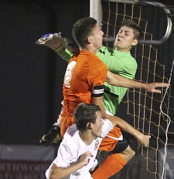 William D. Lewis The Vindicator Canfield goalkeeper Jeff Joseph(03) geeen shirt, blocks a shot as Canfield's Alex Schill(4) is in on the action. Howland's Kyle Watson(4) is also airborne on the play.