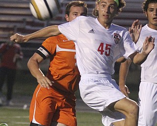 William D. Lewis the Vindicator Canfield's Frank Phillips(45) and Howland's Tyler Spain(7) during 10-3 action in Canfield.