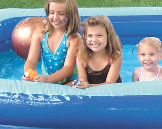 Granddaughters of Martie and Gary Kabetso of Canfield, Zoe and Olivia Kabetso and Chloe Guinter, are enjoying the pool at their grandparents home on July 4.