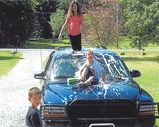 Trystin Nelson, 8, Xavier Nelson, 4, and Chase Nelson, 6, are washing Mom's car. Sent by Kathy Mackall of Columbiana.