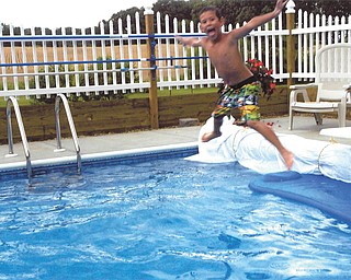 Chase Nelson jumping into Grandma and Pap's pool. Sent by Kathy Mackall of Columbiana.