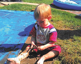 Connor Blanco of Mayfield Heights is caught playing in the mud. He is a grandson of Rochelle Blanco of Boardman.