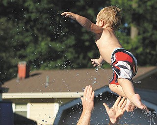 Ben Gaither jumps into his father's arms at the pool. Sent by Ben's grandma, Laurie Fox.