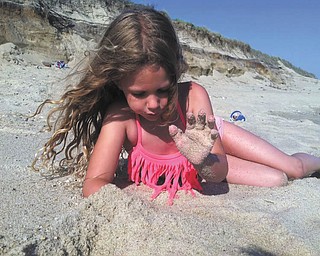 Lilyanah Miller enjoyed the sand on the beach at Nantucket Island with her mom, Erica McElroy, and her dad, Adam Miller.