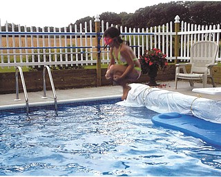 Trystin takes a flying leap into grandma and grandpa's pool. Sent by Kathy Mackall of Columbiana.