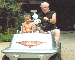 Buck Shipley of Struthers gives his great-grandson, Anthony Shipley, a ride on his antique Harley Davidson 1976 golf cart. Sent by Sue Shipley.
