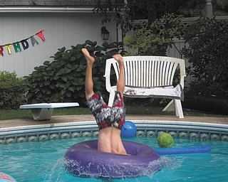 Nick Keshock of Boardman is diving head first into the pool and through the inner-tube at Brian Knotten's birthday party. Taken by Carol Knotten of Boardman.