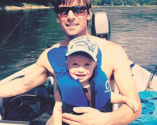 Finnegan and his dad, Justin, are all smiles while waiting for the fish to bite.