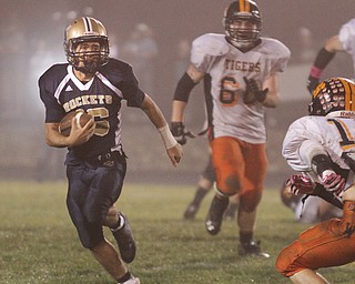 . ROBERT K. YOSAY | THE VINDICATOR..Lowellville #16 picks out a line as he makes a first down during third quarter action at Lowellville - behind hims is Wellsville #60 Levy Brown and #16 Jordan Allen