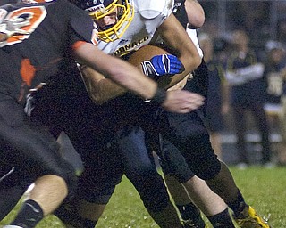 Kelli Cardinal/The Vindicator .McDonald running back Jake Reckard carries the ball Friday against Mineral Ridge defender Josh Goss at Whittaker Field.