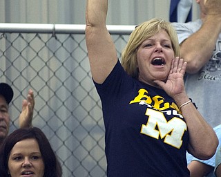 Kelli Cardinal/The Vindicator .Sherri Lowry, from McDonald, cheers for the Blue Devils as they run onto the field Friday before their game against Mineral Ridge at Whittaker Field. Lowry's son, Jake Lowry, is a running back for McDonald.