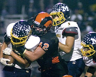 Kelli Cardinal/The Vindicator .McDonald running back Cameron Ifft (ok) carries the ball Friday against Mineral Ridge defender Jake Fowler at Whittaker Field.