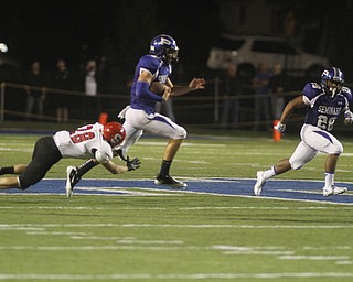 . ROBERT K. YOSAY | THE VINDICATOR..Polands #5 Jacob Wolfe -qb on the keeper breaks the last tackle of Struters #28 Anthony Farkas as he goes 61 yards for a TD with him is polands #28 Marion Ramirez ..Poland vs Struthers @ Poland