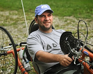 MADELYN P. HASTINGS | THE VINDICATOR..Brett Clingan of Champion has a neurological disorder but is still competing in the Peace Race using a hand cycle and the help of his Labrador Golden Retriever, Albus.... - -30-..