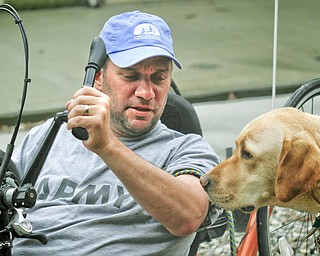 MADELYN P. HASTINGS | THE VINDICATOR..Brett Clingan of Champion has a neurological disorder but is still competing in the Peace Race using a hand cycle and the help of his Labrador Golden Retriever, Albus.... - -30-..