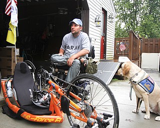 MADELYN P. HASTINGS | THE VINDICATOR..Brett Clingan of Champion has a neurological disorder but is still competing in the Peace Race using a hand cycle and the help of his Labrador Golden Retriever, Albus.... - -30-..