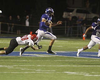 . ROBERT K. YOSAY | THE VINDICATOR..Polands #5 Jacob Wolfe -qb on the keeper breaks the last tackle of Struters #28 Anthony Farkas as he goes 61 yards for a TD with him is polands #28 Marion Ramirez ..Poland vs Struthers @ Poland