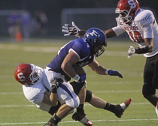 . ROBERT K. YOSAY | THE VINDICATOR..Polands #44 Jake Aiello finally gets stopped by Struthers #28 Anthony Farkas and #10 Temeko Holness of Struthers - during first quarter action..Poland vs Struthers @ Poland