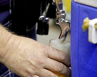 MADELYN P. HASTINGS | THE VINDICATOR..Tim Beauchamp of Boardman pours a Kentucky Bourbon Barrel Ale for a customer at the Beer Fest at the Covelli Center on Saturday, October 5, 2013. ... - -30-..