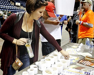 MADELYN P. HASTINGS | THE VINDICATOR..Chelsea Mayer of North Canton tastes raw hops at the PumpHouse Homebrew Shop booth set up at the Beer Fest at the Covelli Center on Saturday, October 5, 2013. The company based out of Struthers offered several types of brewing products for guests to taste.... - -30-..